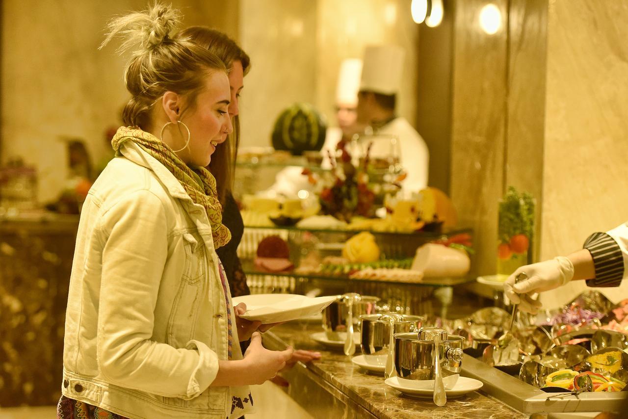 Grand Ocean El Sokhna Hotel Ain Sukhna Exterior photo A woman selecting food from a buffet